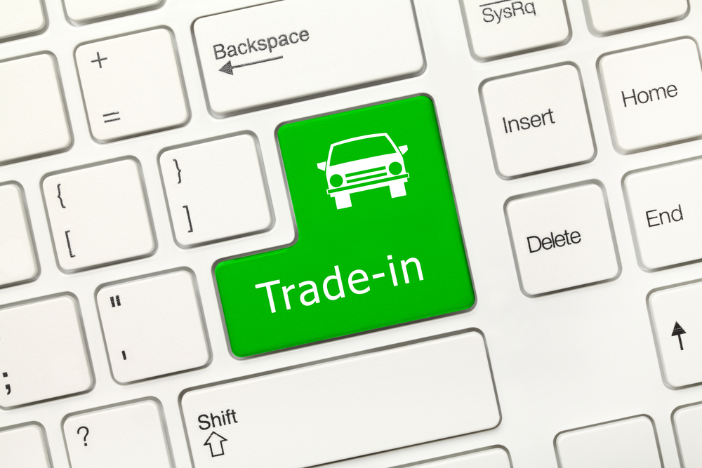 Online vehicle trade-in and valuation concept shown with keyboard and digital graphics, highlighting easy, fast, and convenient upgrade process.