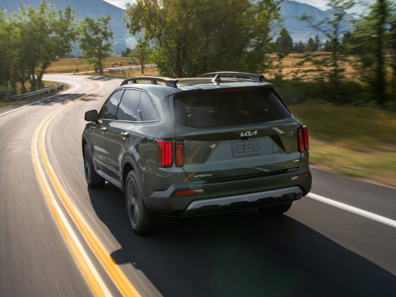 Kia Sorento driving on a winding mountain road.